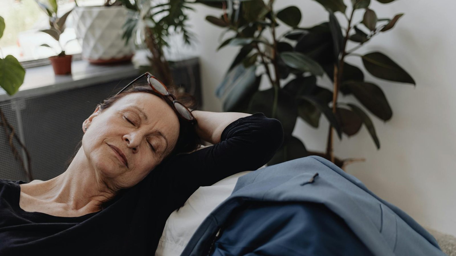 An adult woman in a quiet, contemplative moment at home