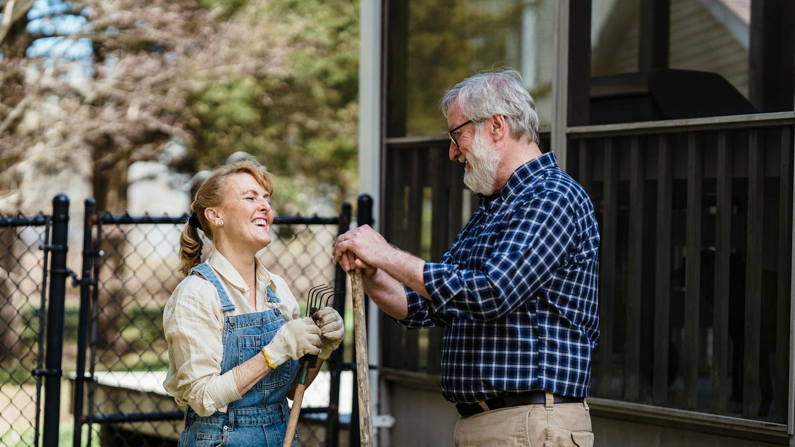 An older couple sharing a genuine laugh together in a homey residential setting