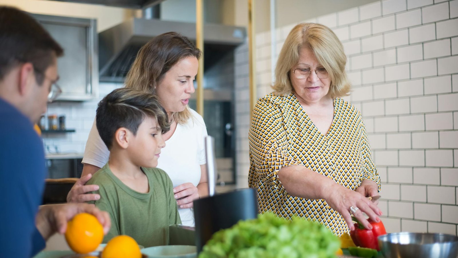 A multigenerational family preparing a meal together in a kitchen